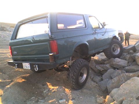 1991 Ford Bronco - This modified Ford Bronco is navigating a rocky terrain, its off-road capabilities.