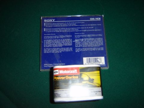 1992 Ford Bronco - Sony CD-R disc packaging and a Motorcraft PowerSeries oil filter are shown on a green surface.