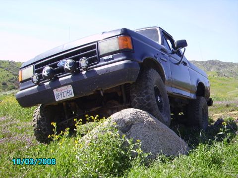 1990 Ford Bronco - This 1990 Ford Bronco is shown navigating an off-road obstacle.