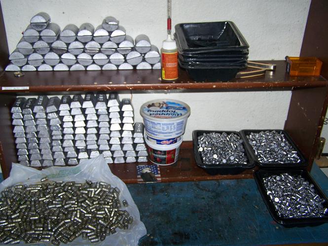 Stacks of lead ingots and containers filled with bullets on shelves
