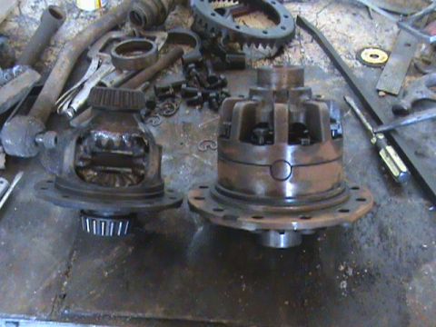1987 Ford Bronco - Differential assemblies and gears are laid out on a workbench, possibly for repair or modification.