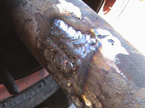 1987 Ford Bronco - A metal pipe shows signs of recent welding work.