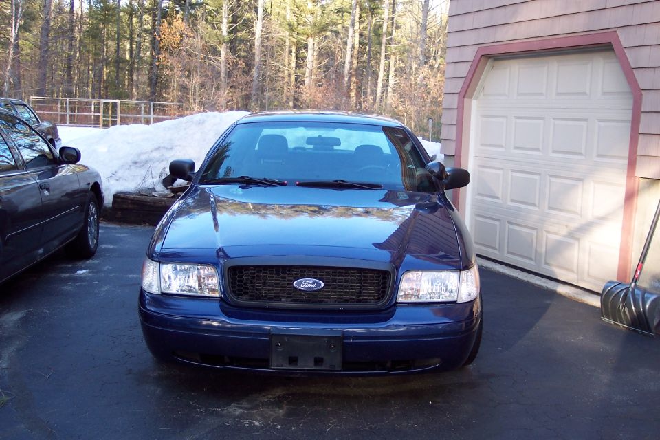 Blue 2001 Ford Crown Victoria parked in driveway, front view