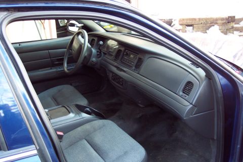 2001 Ford Crown Victoria - Interior view of a blue sedan, highlighting the dashboard and seating area.