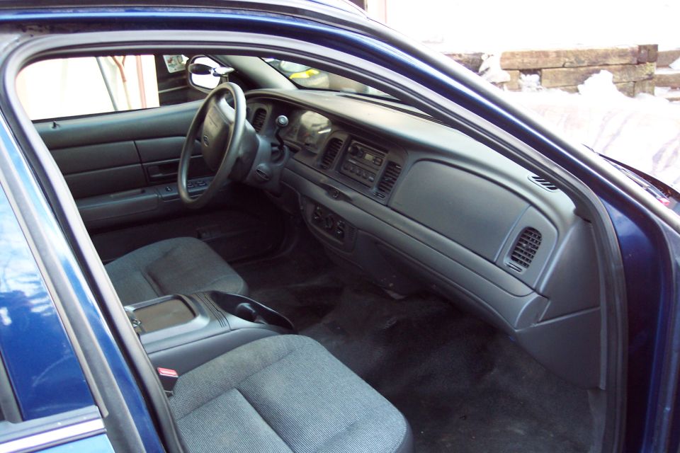 Blue car interior, showing dashboard, steering wheel, and front seats