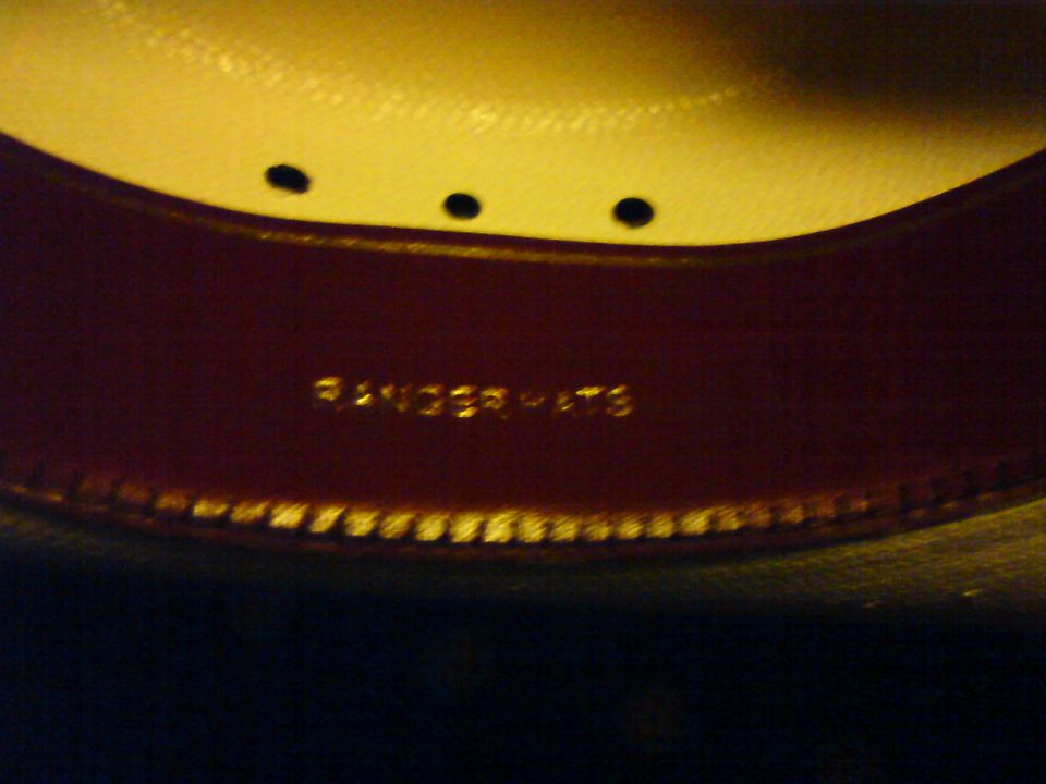 Close-up of the inside band of a hat with "RANGER HATS" stamped in gold lettering