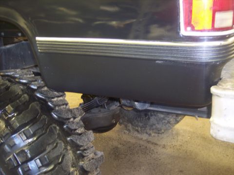 1984 GMC Sierra 3500 - Close-up of the rear fender and large tire on a black 1984 GMC Sierra 3500 pickup truck.
