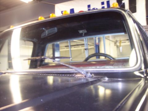 1984 GMC Sierra 3500 - The photo shows the interior of a truck cab, focusing on the windshield and dashboard area, with amber lights visible on the roof.