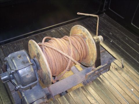1984 GMC Sierra 3500 - A winch and coiled rope are visible in the bed of a truck, with a Supermotors.net logo in the corner.