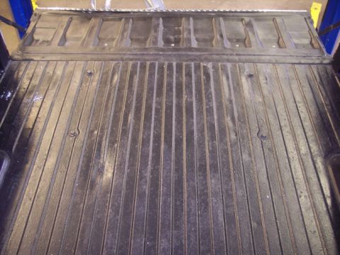 1984 GMC Sierra 3500 - The ribbed truck bed of a 1984 GMC Sierra 3500 shows some wear and tear.