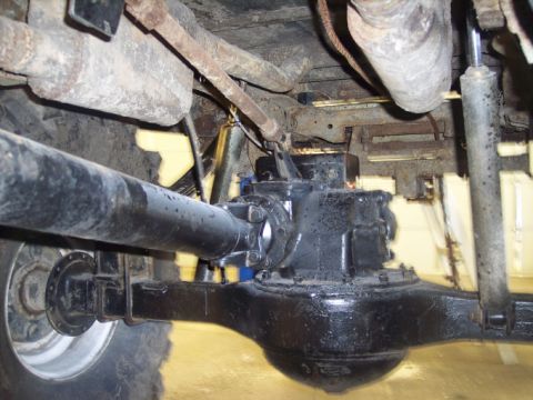 1984 GMC Sierra 3500 - Underside view of a truck's rear axle and driveshaft assembly, showing suspension components.