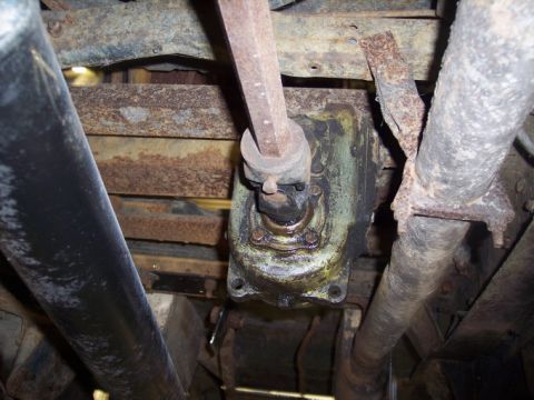 1984 GMC Sierra 3500 - Close-up of the steering box and linkage assembly on a vehicle's undercarriage.