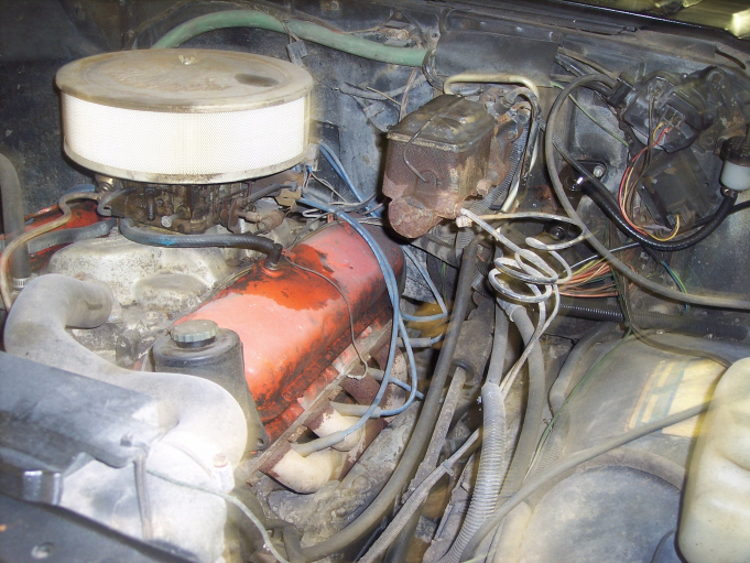 Engine bay with carburetor, air cleaner, and brake master cylinder