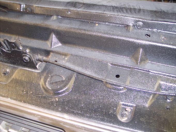 close-up of black painted truck frame with some bolts and brackets