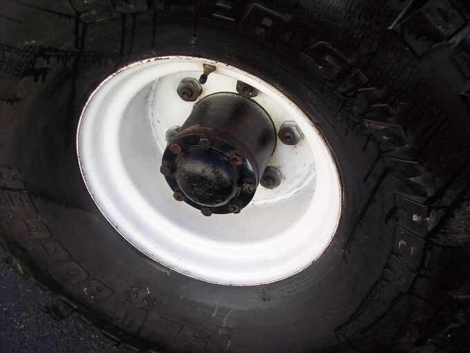 Super Swamper Bogger tire on a white 8-lug steel wheel with full-floating hub