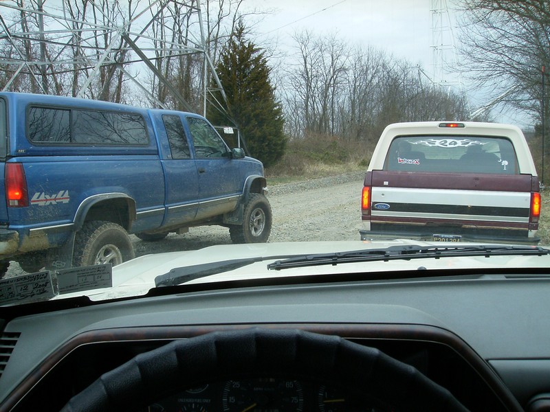Rear view of a 1987 Ford Bronco with a maroon stripe