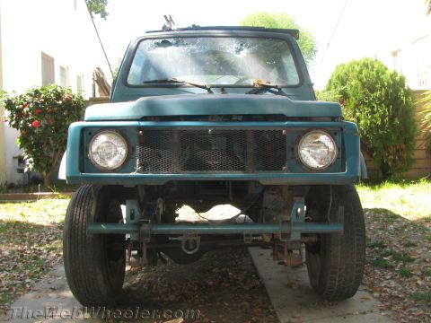 1987 Suzuki Samurai - This 1987 Suzuki Samurai is shown from the front, a custom bumper and a cracked windshield.