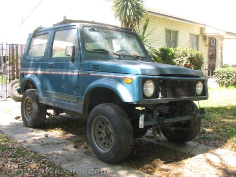 1987 Suzuki Samurai - This 1987 Suzuki Samurai has a missing grille and a cracked windshield.