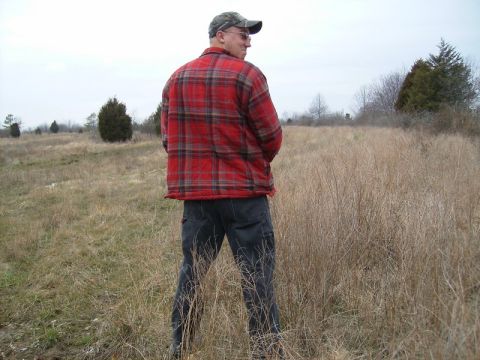 1988 Ford Bronco - A man stands in a field, looking away from the camera.