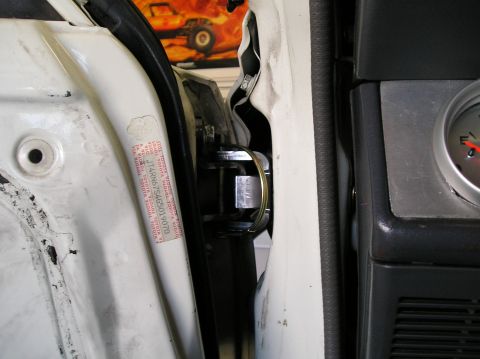 1986 Toyota Hilux - Close-up view of the door jamb on a 1986 Toyota Hilux, showing a VIN sticker and an interior gauge.