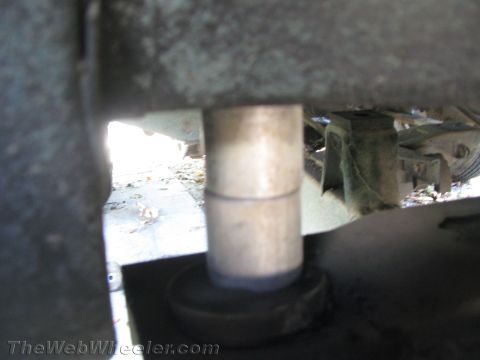 1987 Suzuki Samurai - A close-up view of a vehicle's undercarriage reveals a metal suspension part with a distinct seam.
