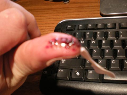 1993 Ford Bronco - A decorated fingernail is held over a computer keyboard.