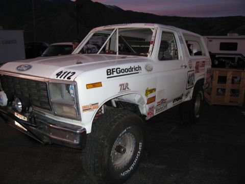 1986 Ford Bronco - This modified 1980s Ford Bronco features a roll cage and BFGoodrich tires, suggesting off-road use.