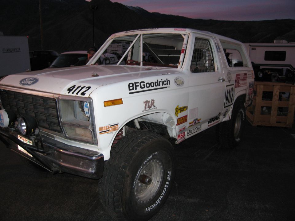 White 1980s Ford Bronco with roll cage and BFGoodrich tires