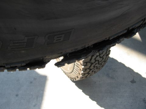 1986 Ford Bronco - Close-up of a damaged BFGoodrich All-Terrain T/A tire, showing a torn sidewall.