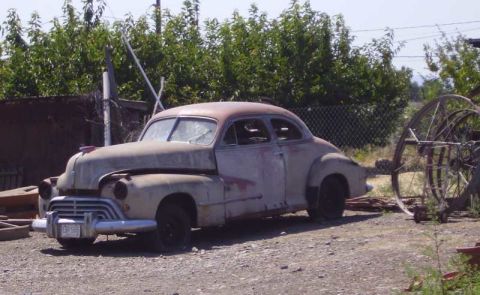 1969 Lincoln Continental - This old car is in rough condition, with visible rust and damage.