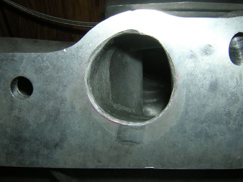 1979 Ford Bronco - Close-up view of a ported cylinder head intake runner, showing the machined opening.