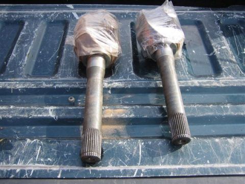 1994 Ford Bronco - Two drive shafts are shown in a truck bed, wrapped in plastic for protection.