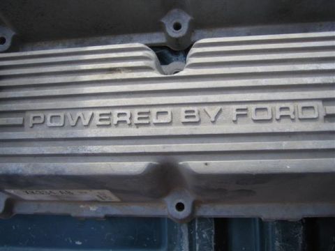 1994 Ford Bronco - Close-up of an engine part showing the 'POWERED BY FORD' inscription.