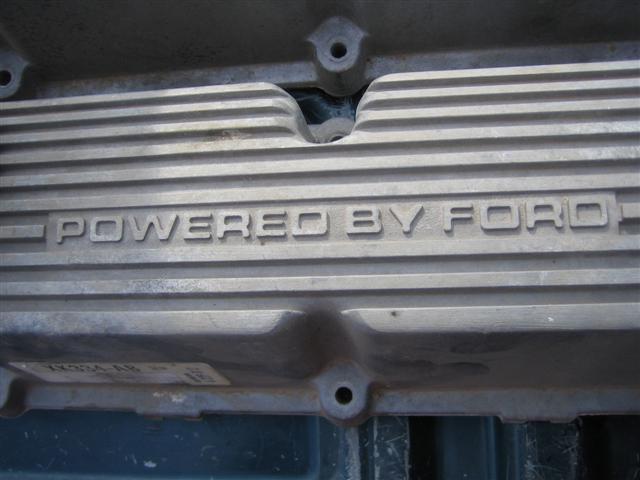 Aluminum engine valve cover with 'POWERED BY FORD' embossed