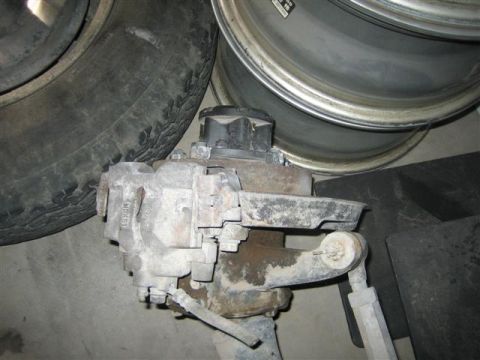 1994 Ford Bronco - A close-up shows a vehicle's brake caliper assembly next to a tire and wheel rim.