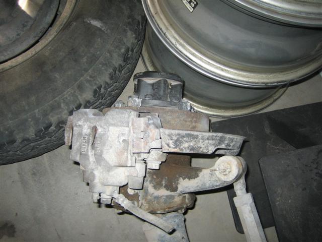 Close-up of a vehicle's brake caliper and part of a tire and wheel