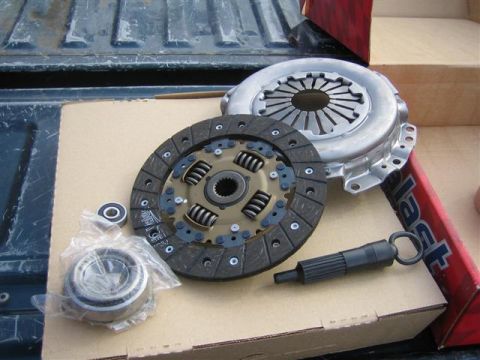 1994 Ford Bronco - Clutch kit components including disc, pressure plate, pilot bearing, and alignment tool.