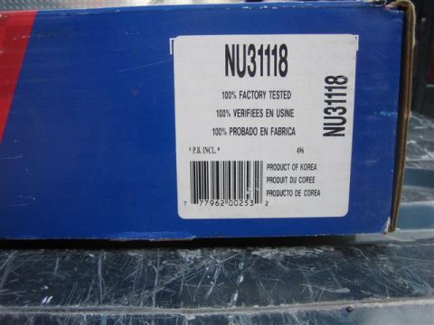 1994 Ford Bronco - A close-up of a blue box containing a vehicle part, with product information and a barcode clearly visible.