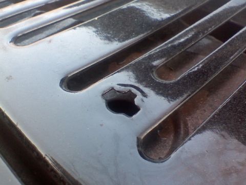 1981 Ford F-250 - Detail of a black grille, showing a hexagonal opening within its slats.