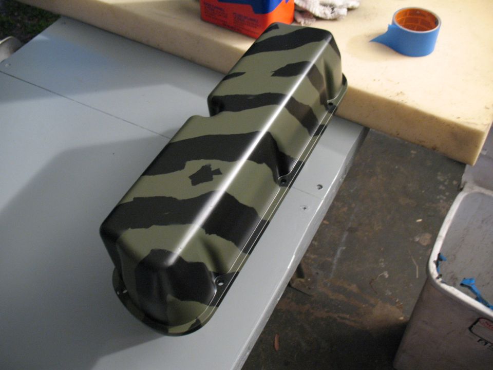 Camouflaged valve cover on a workbench