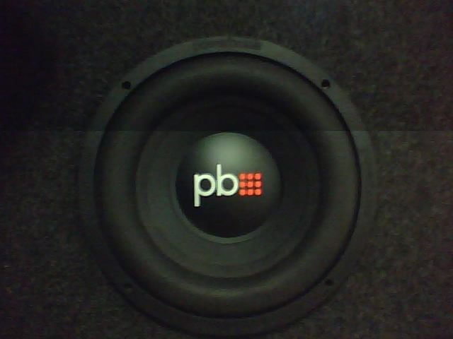 Subwoofer speaker with 'pb' logo and red grid pattern