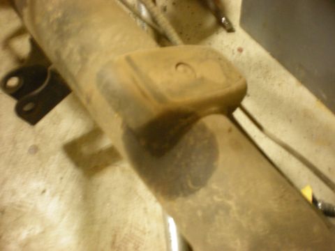 1993 Ford Bronco - A close-up view of a dirty automotive suspension component, with the Supermotors.net logo visible in the lower right corner.
