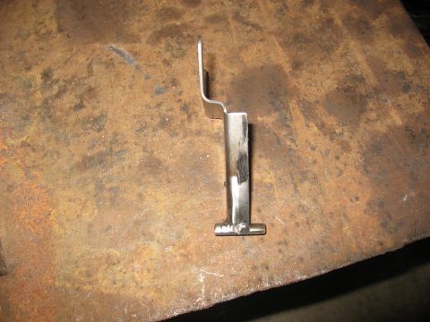1990 Ford F-250 - A single metal bracket is shown against a textured, rusty background.