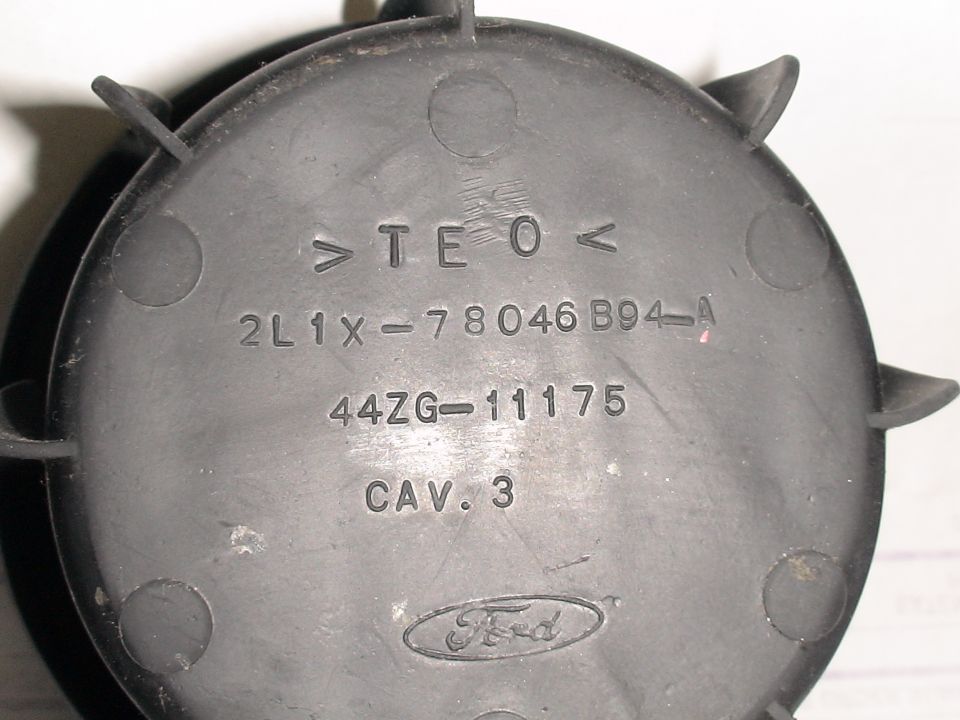 Black plastic Ford part with part number 2L1X-78046B94-A and Ford logo