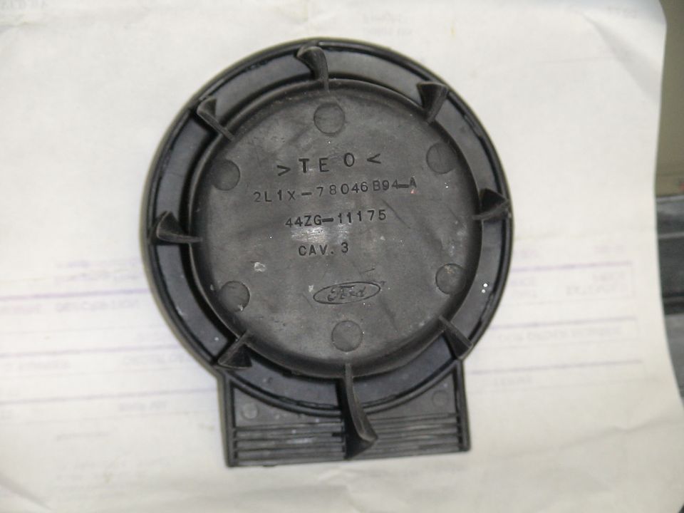Back of a black Ford part with text and Ford logo