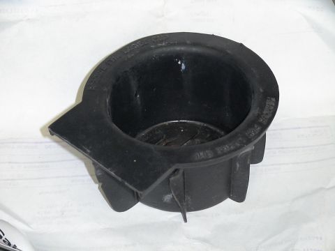 1993 Ford C-350 (Centurion Conversions) - A black plastic cup holder is shown from a top-down angle, with text indicating it can be modified for larger cups.