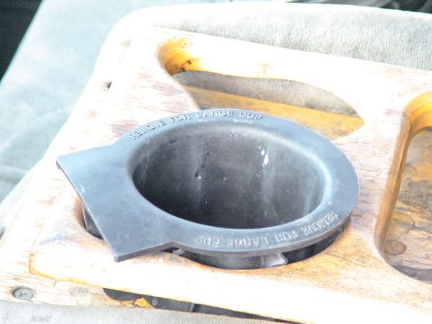1993 Ford C-350 (Centurion Conversions) - Close-up of a vehicle's cup holder, text indicating it is designed for large cups.