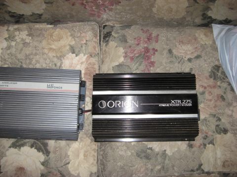 1990 Ford F-250 - Two car amplifiers, a silver HF-tronics and a black Orion XTR 275, are displayed on a floral couch.