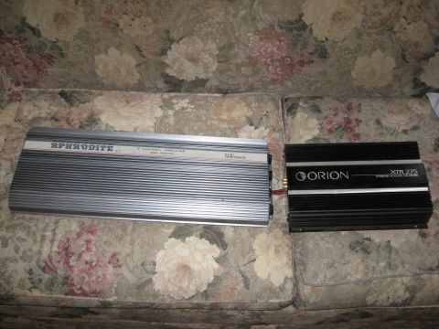1990 Ford F-250 - Two car amplifiers, a silver Aphrodite and a black Orion XTR 275, are displayed on a floral-patterned couch.