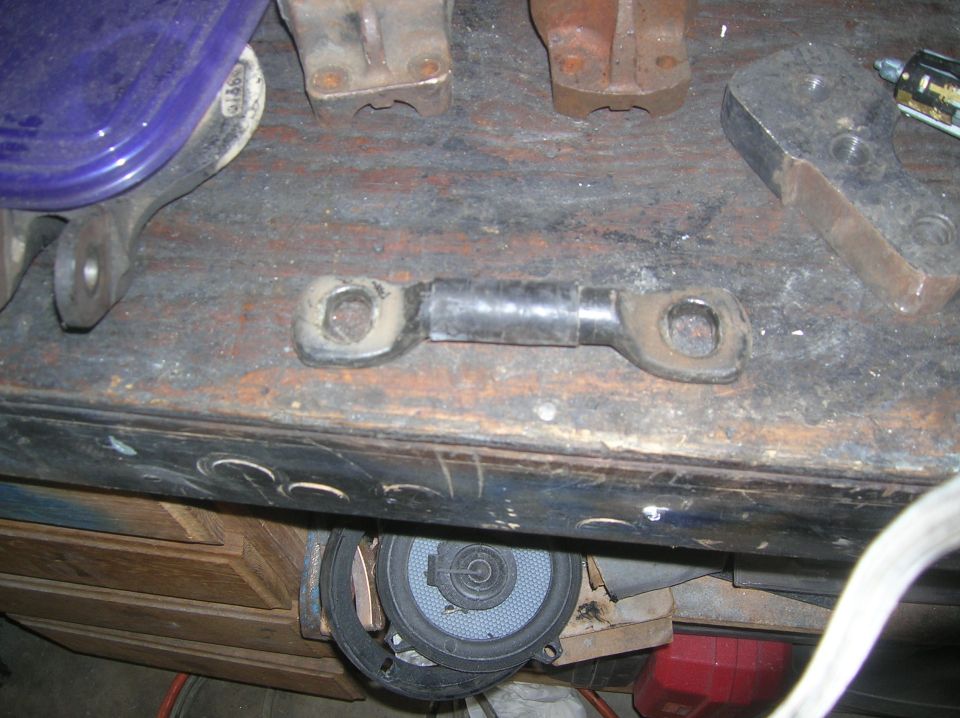 metal linkage with rubber boot on workbench
